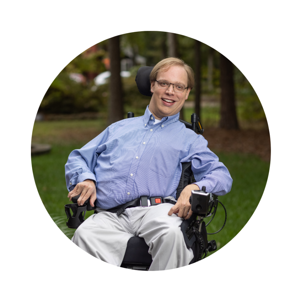 A photo of Matthew Shapiro, a white man using a power wheelchair.