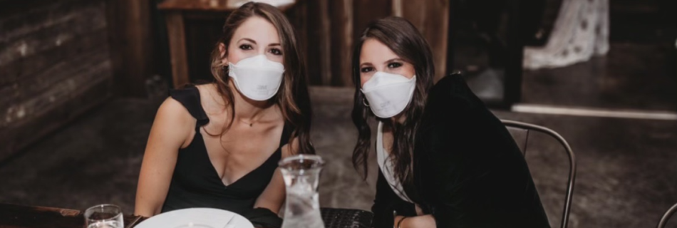 Alexa and Jacqueline at an event wearing masks.