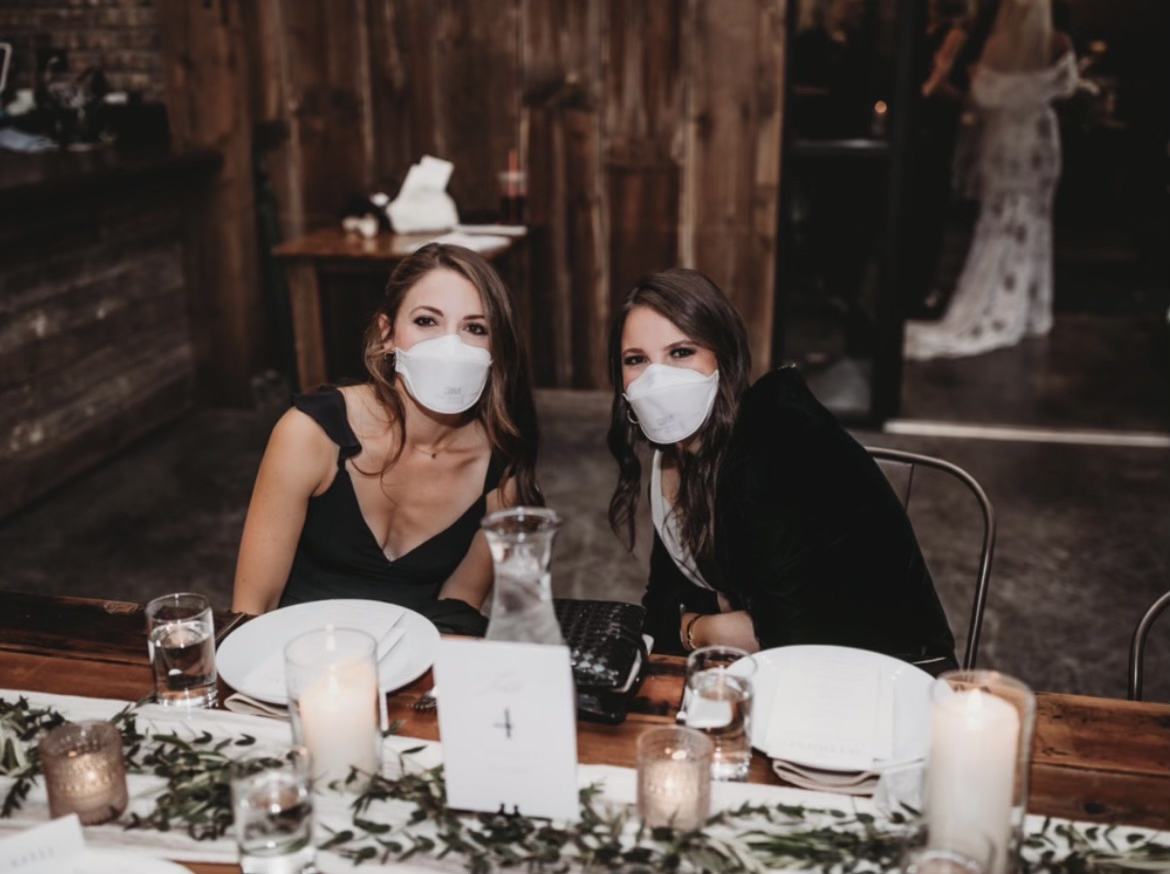 Alexa and Jacqueline at an event wearing masks.