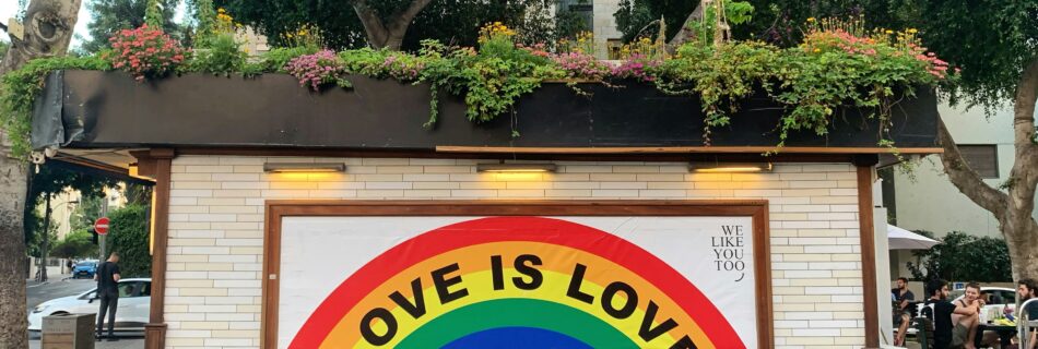 A mural with a painted rainbow that says "Love is Love.