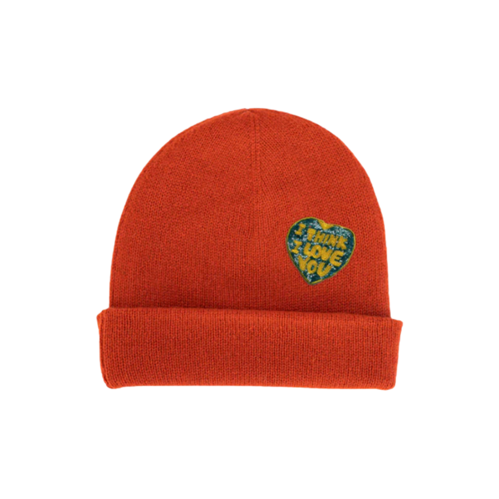 An orange cashmere beanie with a patch that says, "I Think I love you"