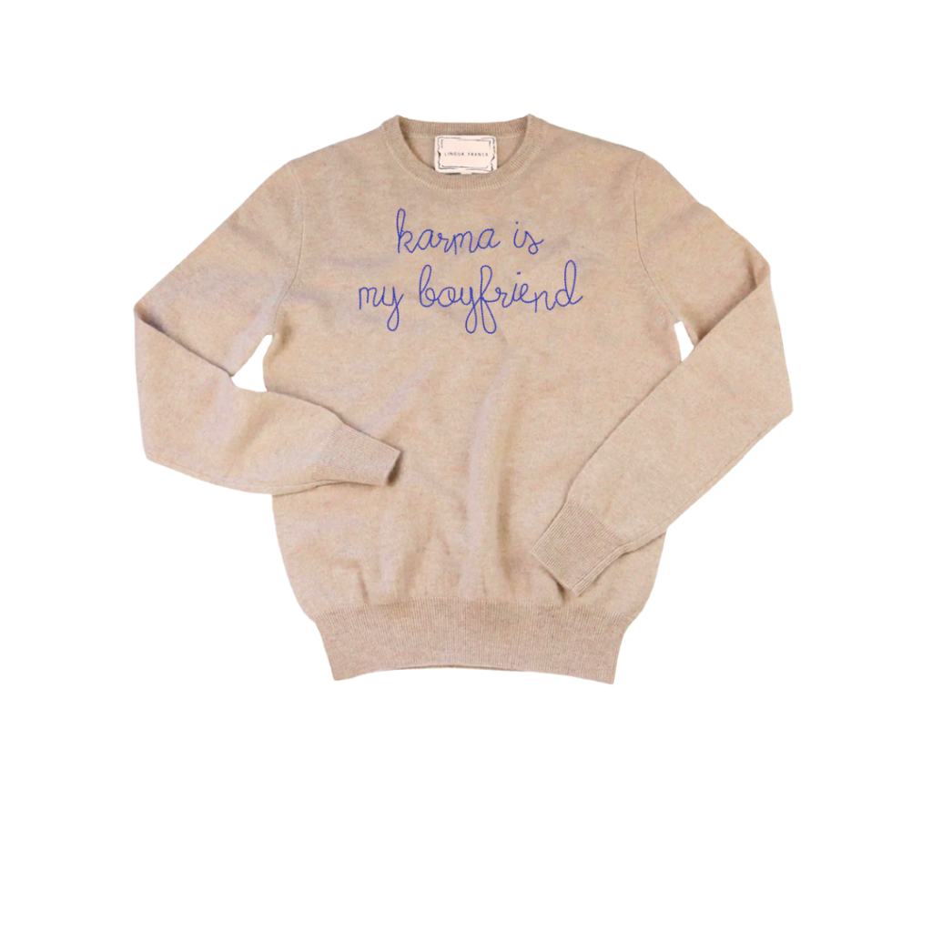 An oatmeal colored sweater with "karma is my boyfriend" embroidered on it from Lingua Franca.